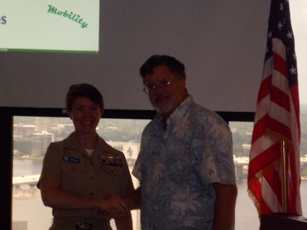 JACKSONVILLE—Capt. Bob Whitkop, USN (Ret.), chapter president, thanks Capt. Carrie Hasbrouck, USN, commander, Defense Information Systems Agency U.S. Special Operations Command, for her presentation in June.
